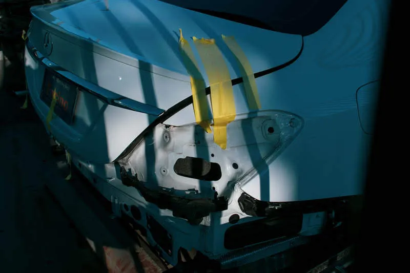 The crumpled rear end of a car damaged in a collision