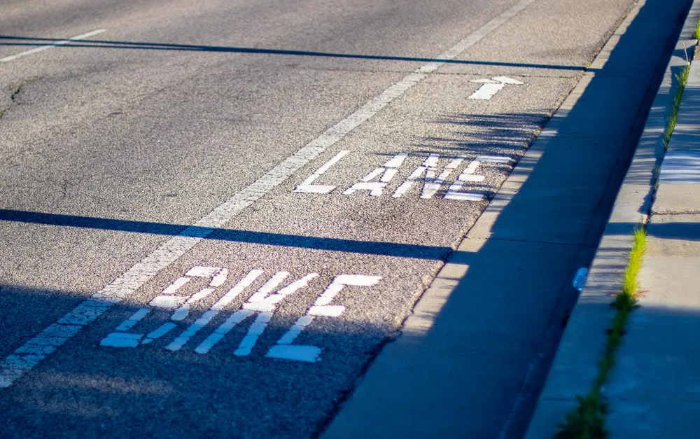 A painted bike lane marking on a roadway