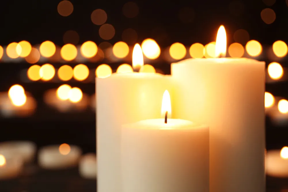 Lit pillar candles glowing against a dark background