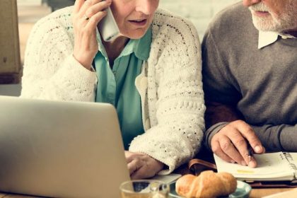 senior-adult-holding-tablet-reading-concept-PJSQ74Q
