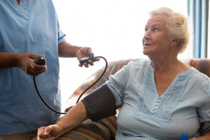 nurse-examining-patient-in-nursing-home-MVLP4XG