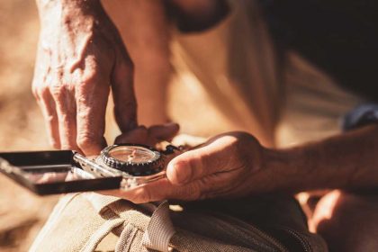 man-using-compass-for-directions-PRAQVLA