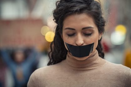 woman-fighting-against-harassment-with-closed-eyes-XFESF4J